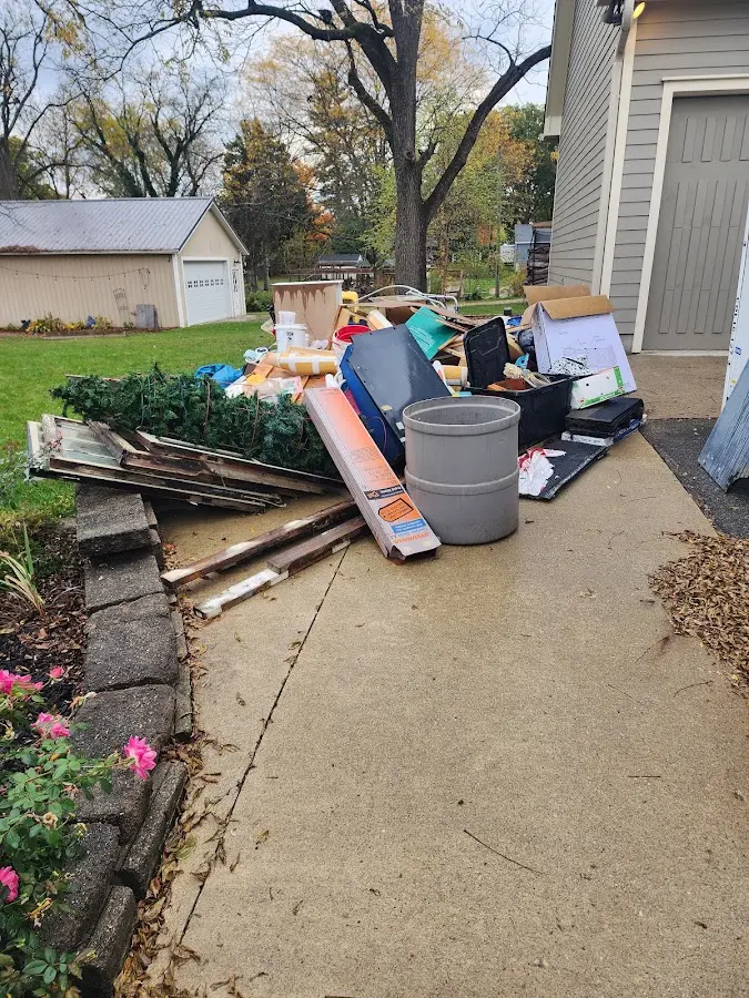 Dumpster being loaded with debris for Residential Dumpster Rental in Fort Mohave